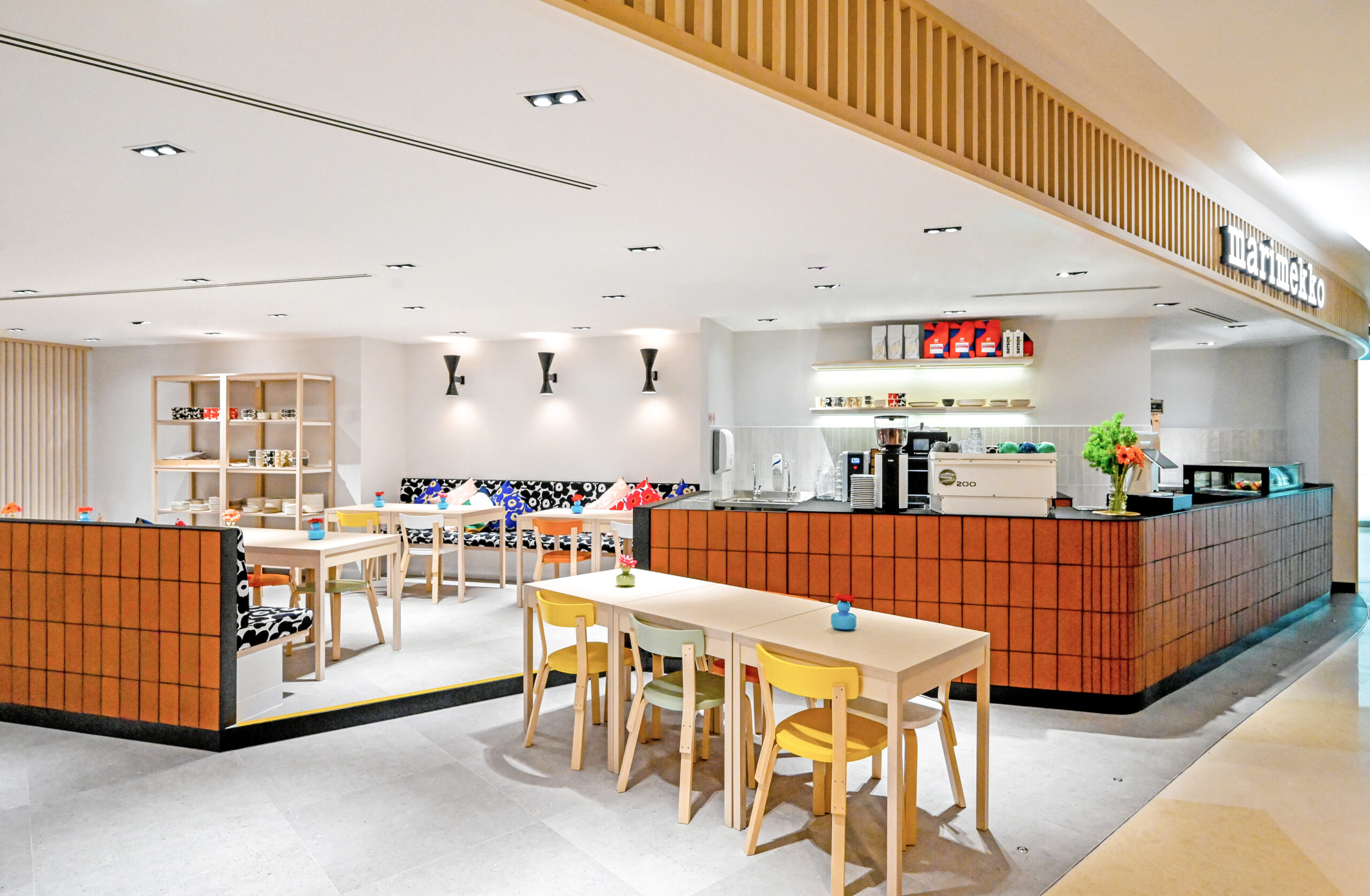 Marimekko Café dining area with colourful textiles and warm lighting