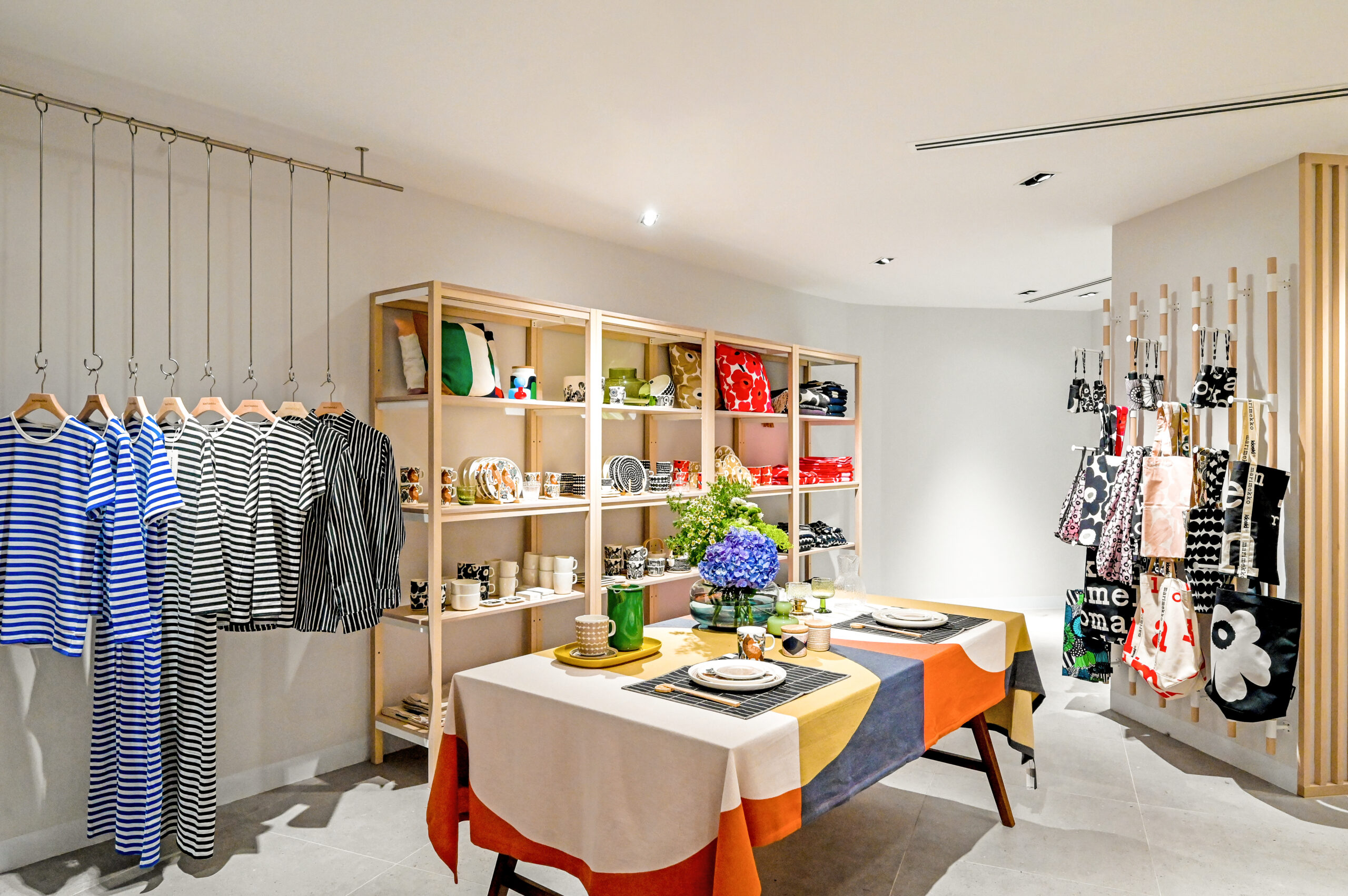 Marimekko product display with fashion, tableware and printed accessories