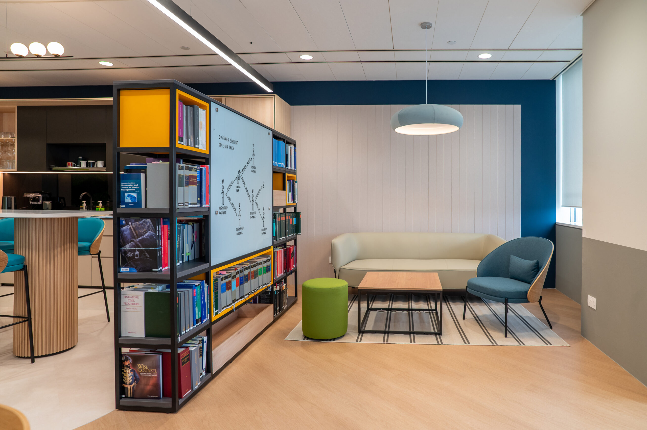 Office breakout area with cityscape mural, bookshelf and biophilic moss walls