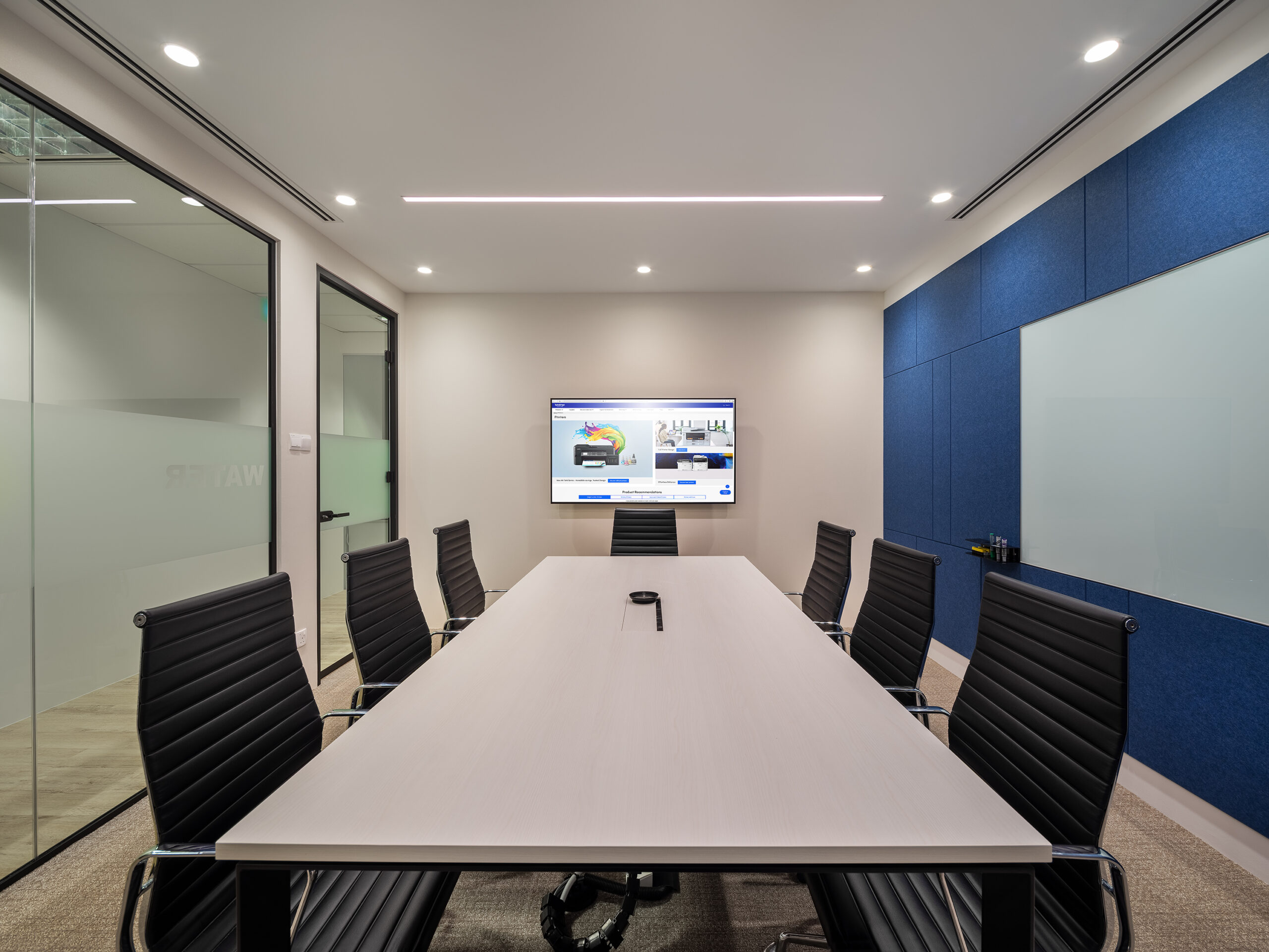 Brother office meeting room with blue acoustic panels and presentation screen