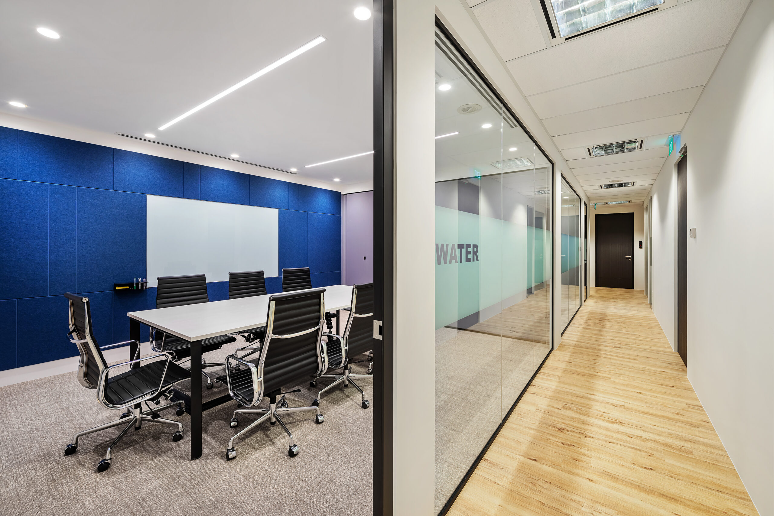 Brother office meeting room with blue acoustic panels and presentation screen