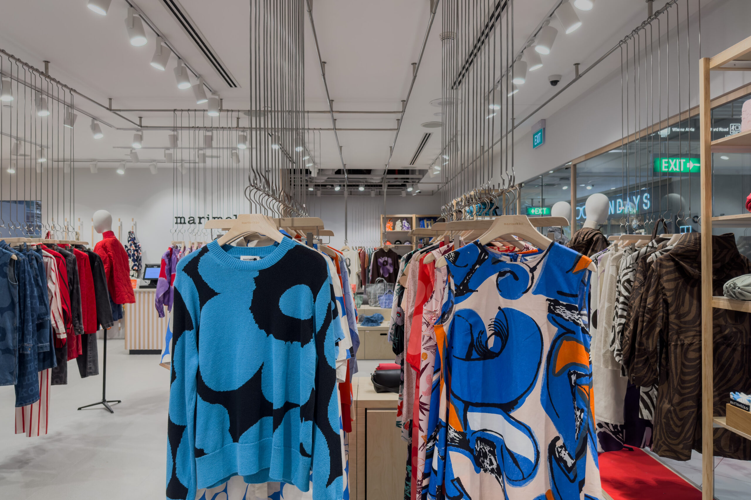 Marimekko fashion boutique with ceiling-hung clothing displays in Singapore