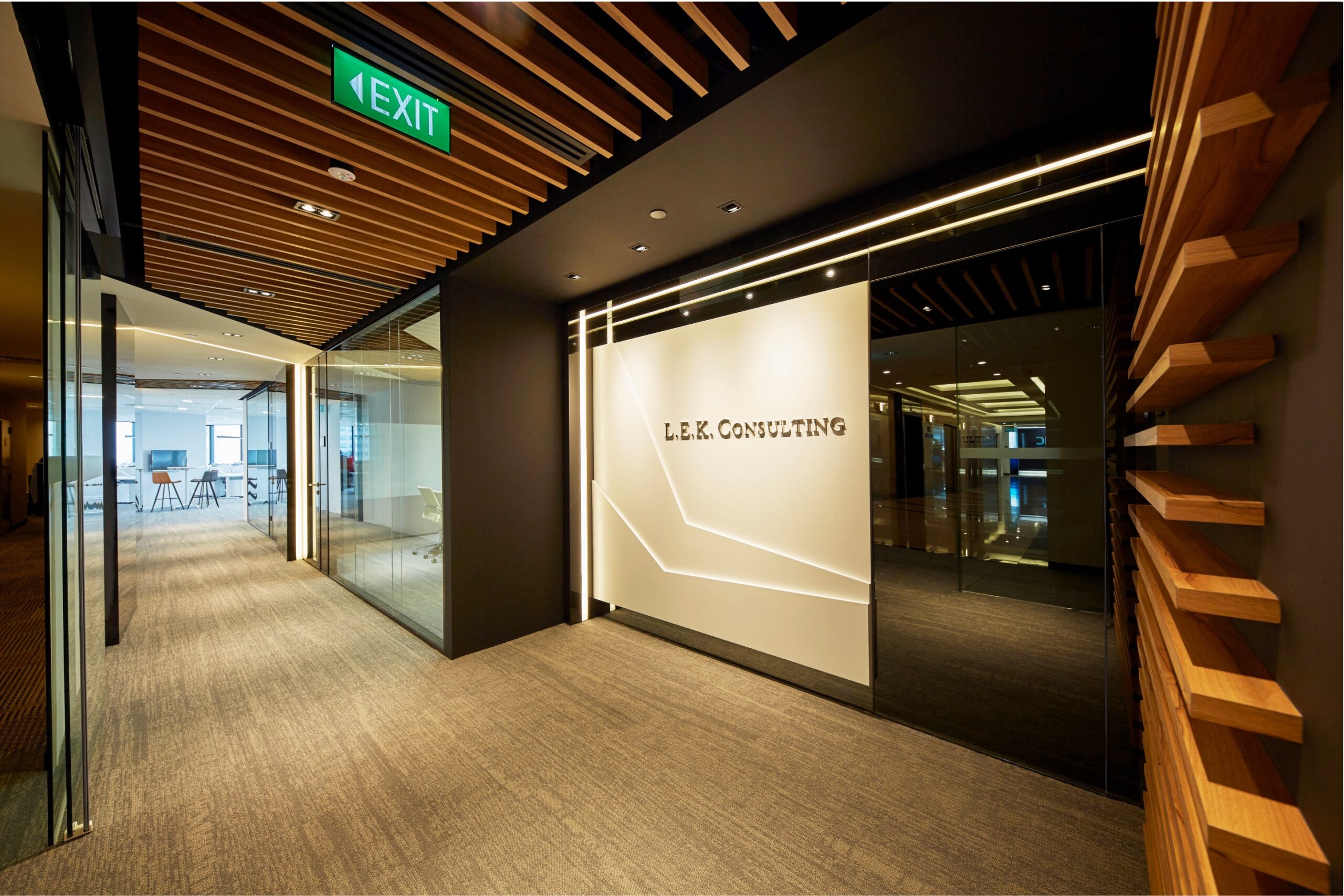 L.E.K. Consulting entrance with illuminated logo wall and timber ceiling slats