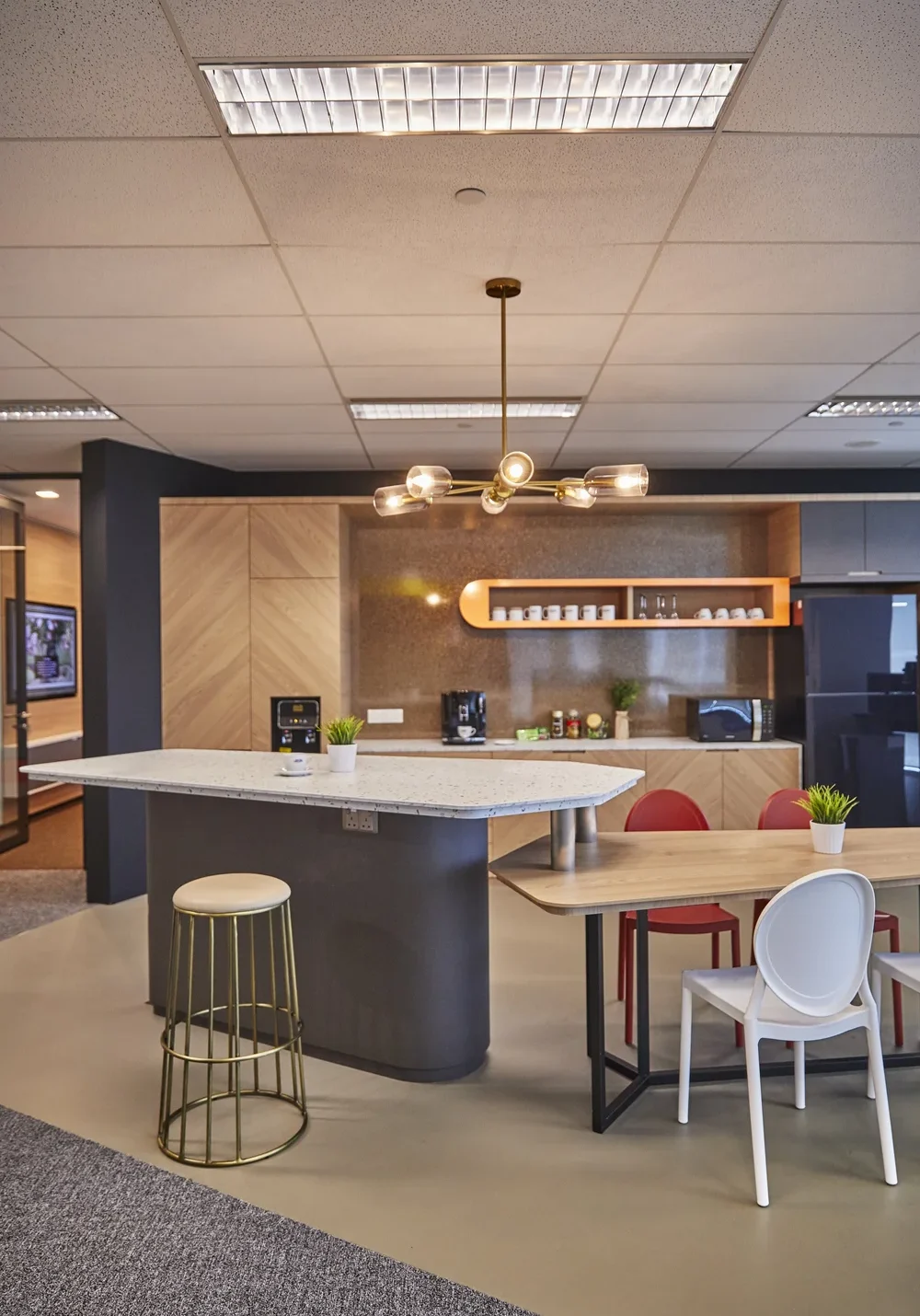 Modern office pantry with timber cabinetry, island counter and dining area
