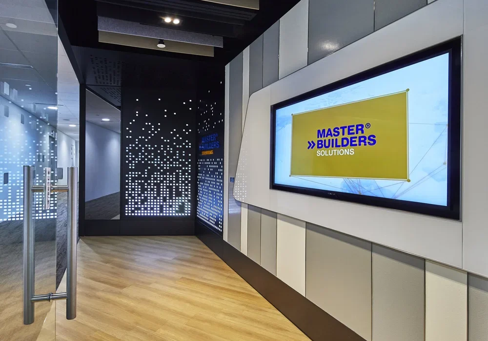 Branded office entrance with illuminated wall panels and digital display