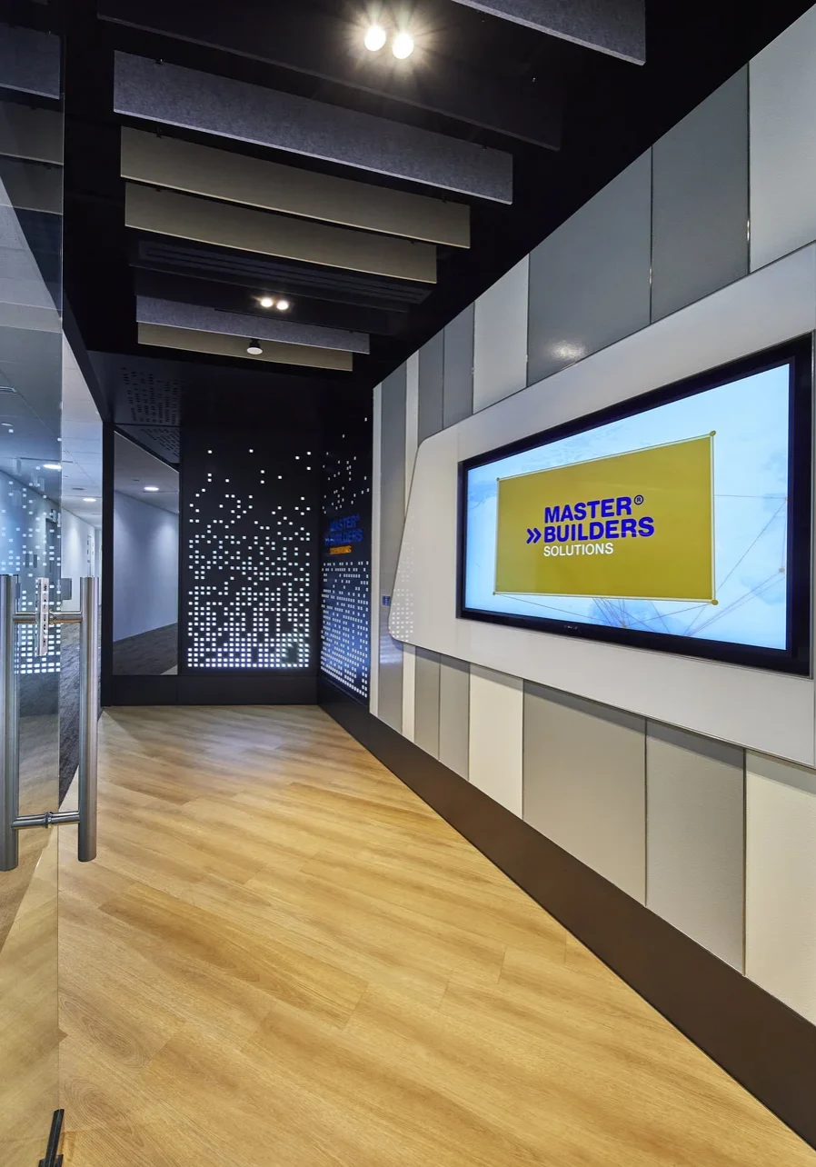 Branded office entrance with illuminated wall panels and digital display