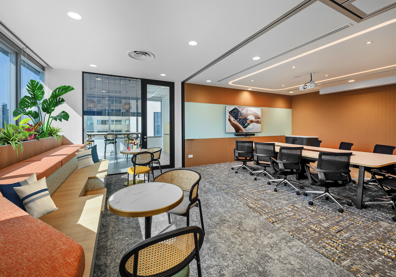 Arohi office breakout lounge with informal seating and Singapore city views