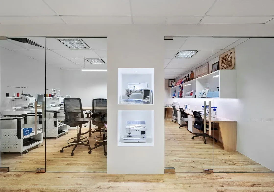 Brother tailoring room with sewing machines and customer-visible workstations