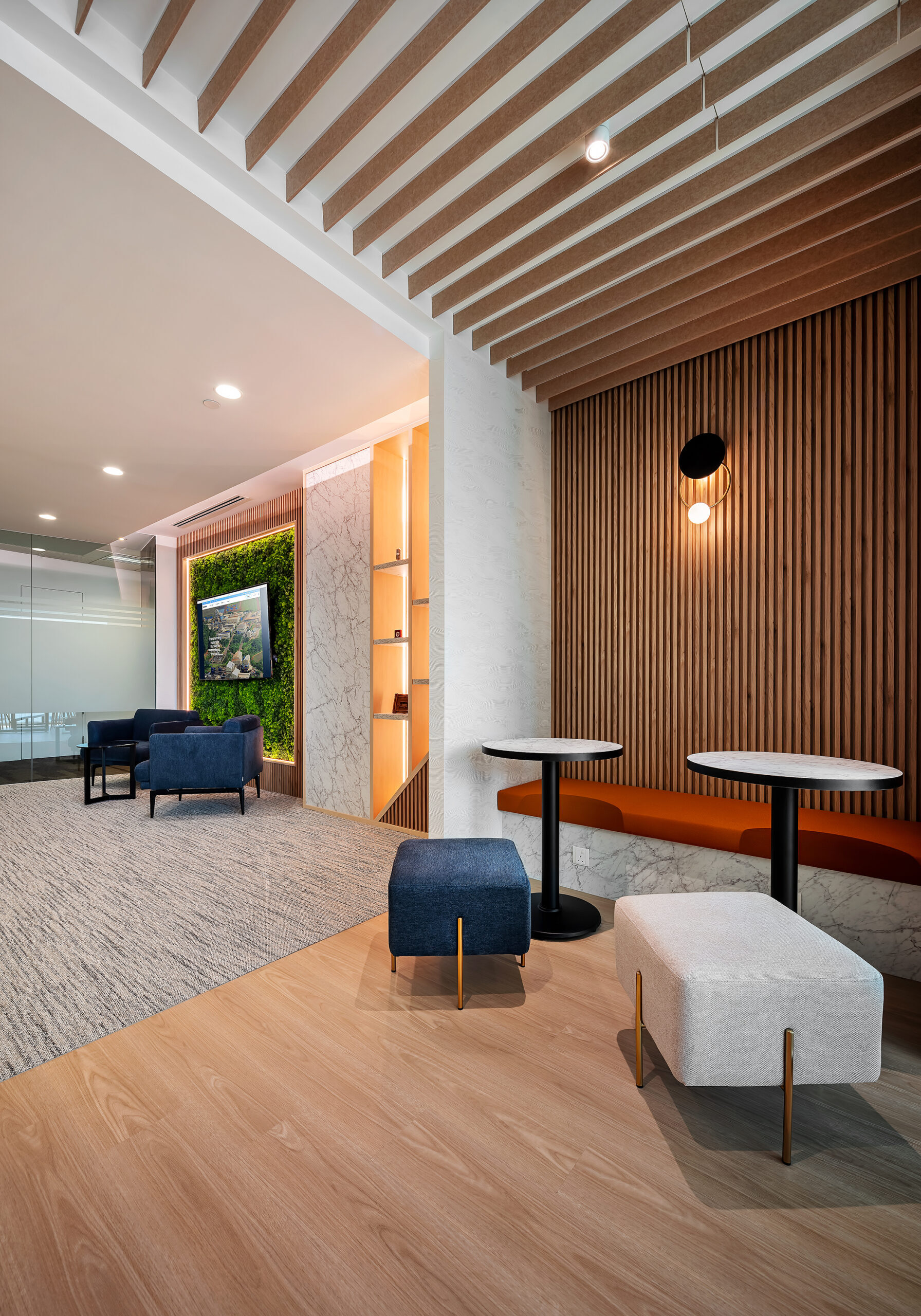 CBMM office breakout lounge with preserved moss wall and collaborative seating
