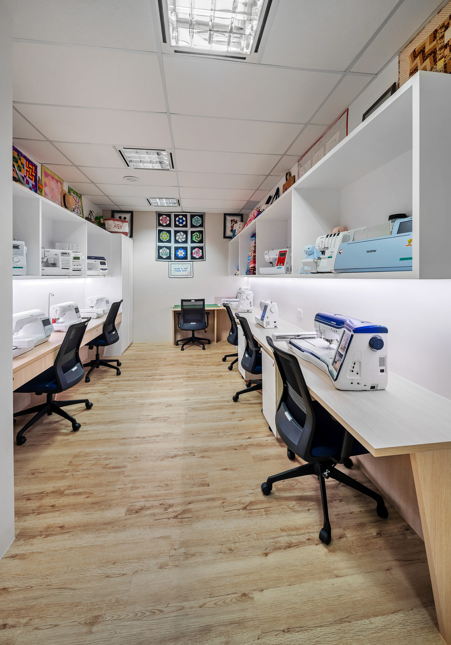 Brother training room with sewing equipment and digital presentation screen