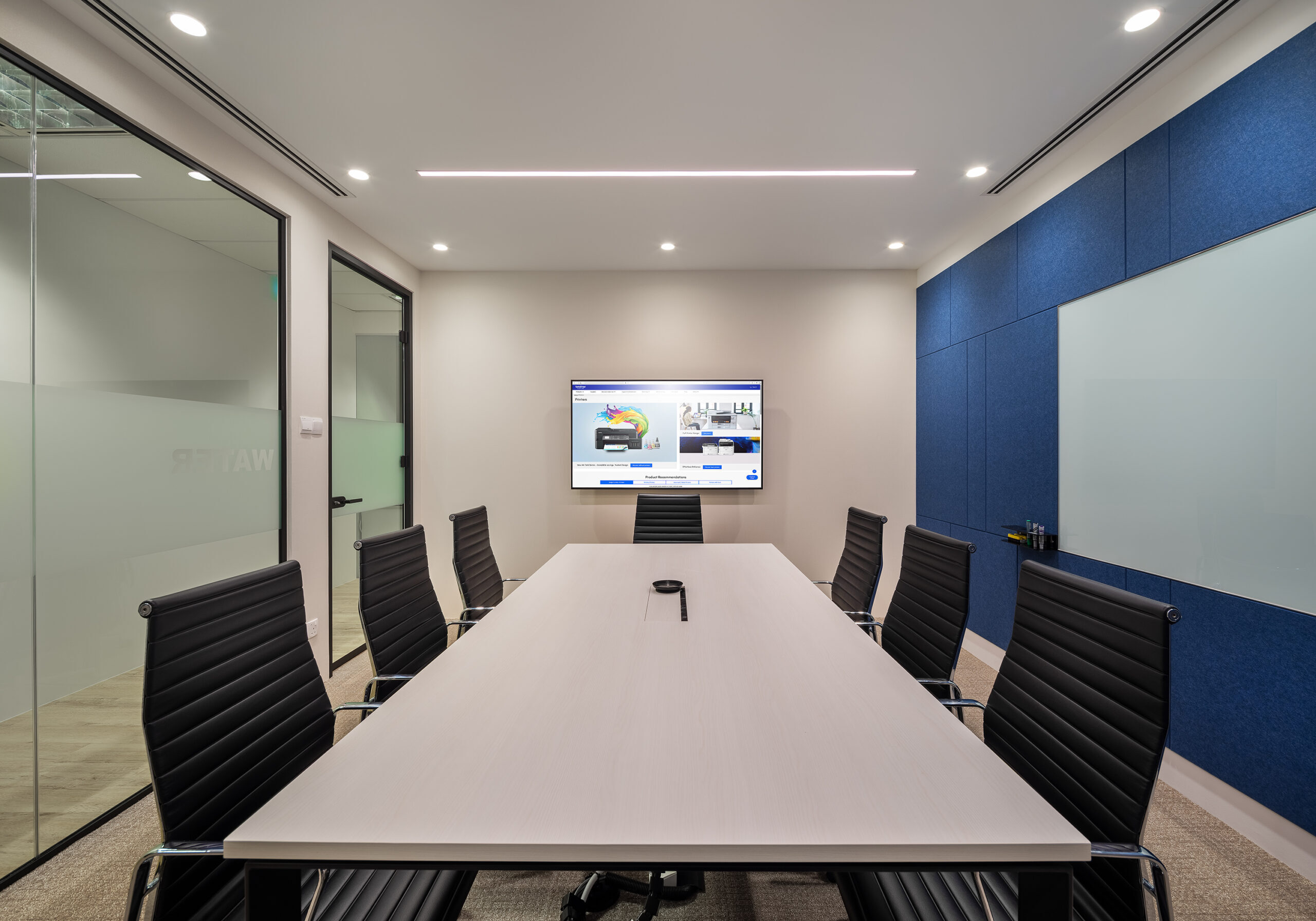Brother office meeting room with blue acoustic panels and presentation screen