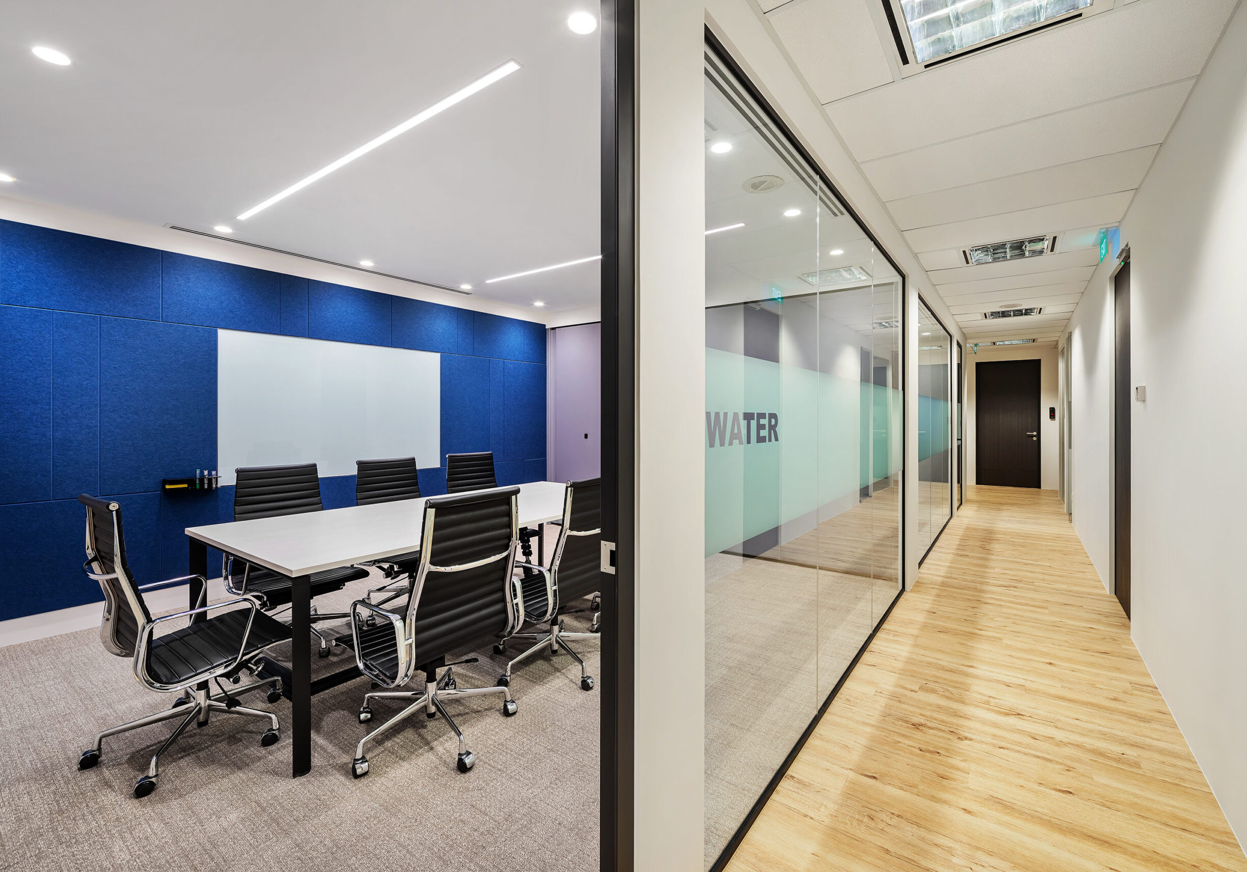 Brother office meeting room with blue acoustic panels and presentation screen