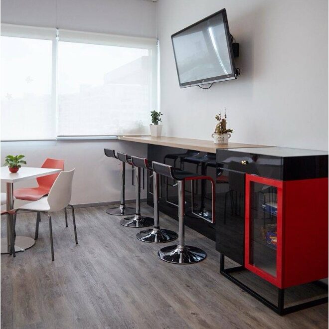 LANXESS branded pantry with black counter seating and red cabinet