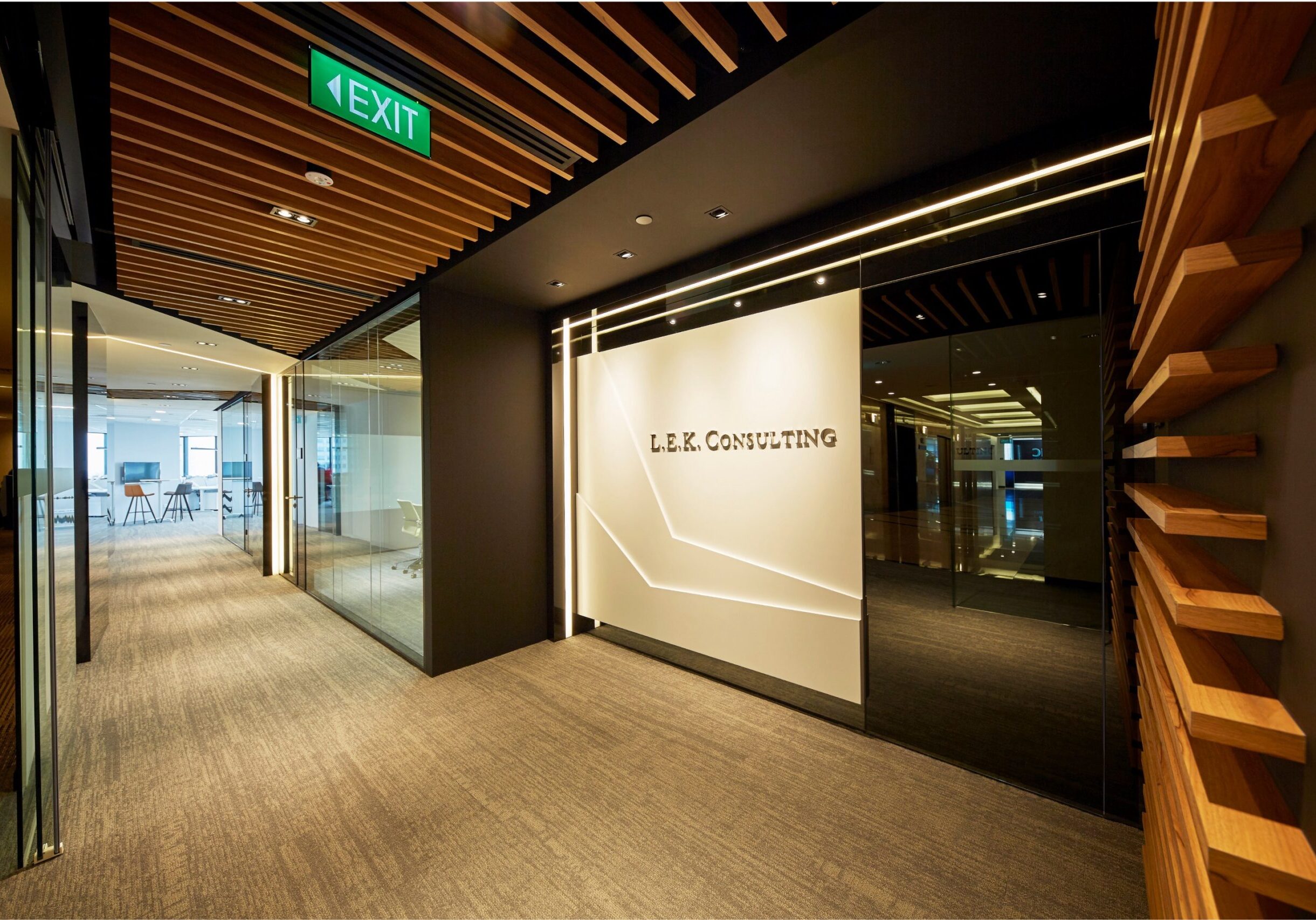 L.E.K. Consulting entrance with illuminated logo wall and timber ceiling slats