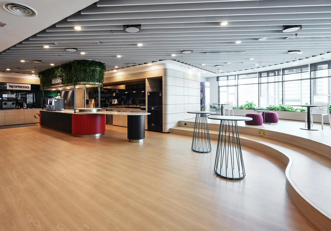 Nestlé office lounge with curved seating and glass-lined interior