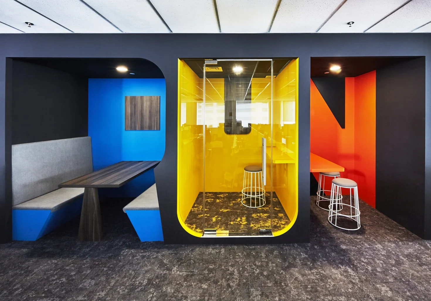 Colourful ASICS office focus booths for meetings and individual work