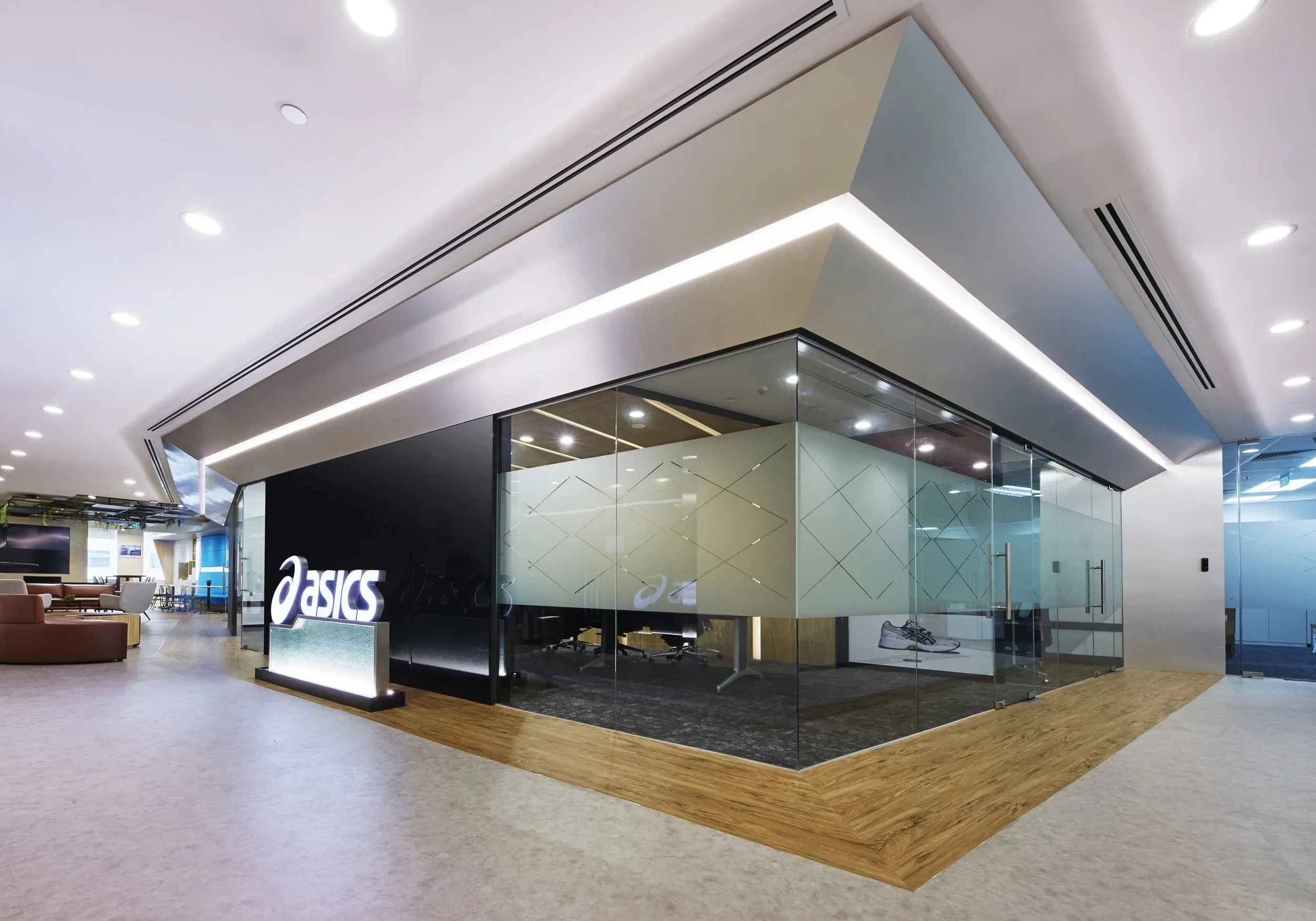 ASICS office entrance with illuminated logo and glass meeting rooms