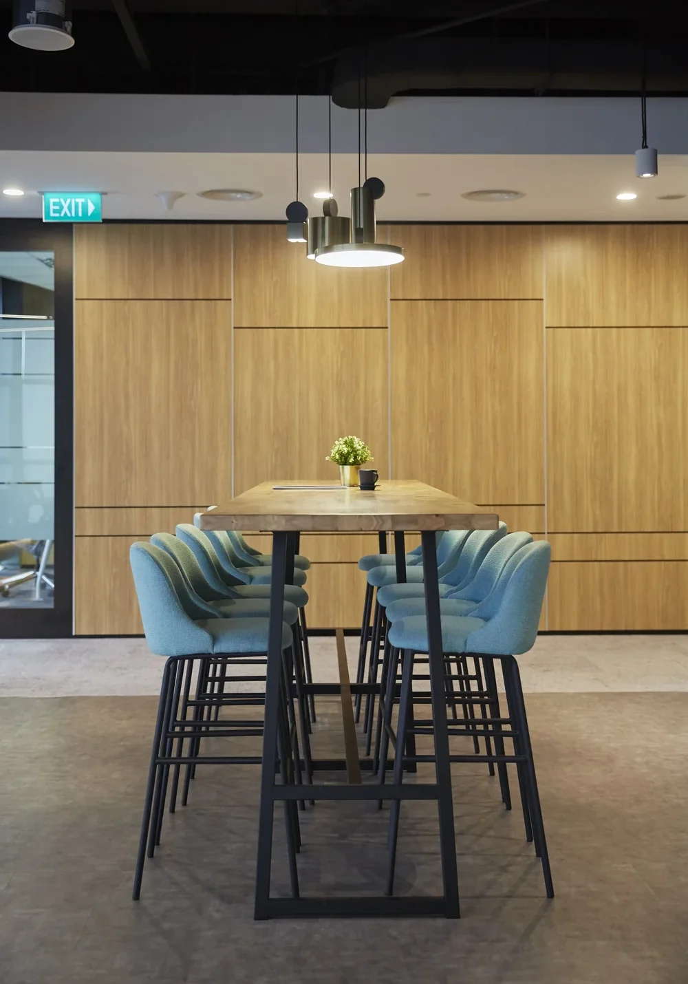 GfK informal meeting area with timber high table and blue upholstered chairs