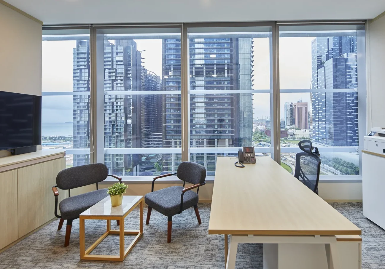 Persistent Asset private office with timber furniture and Marina Bay views