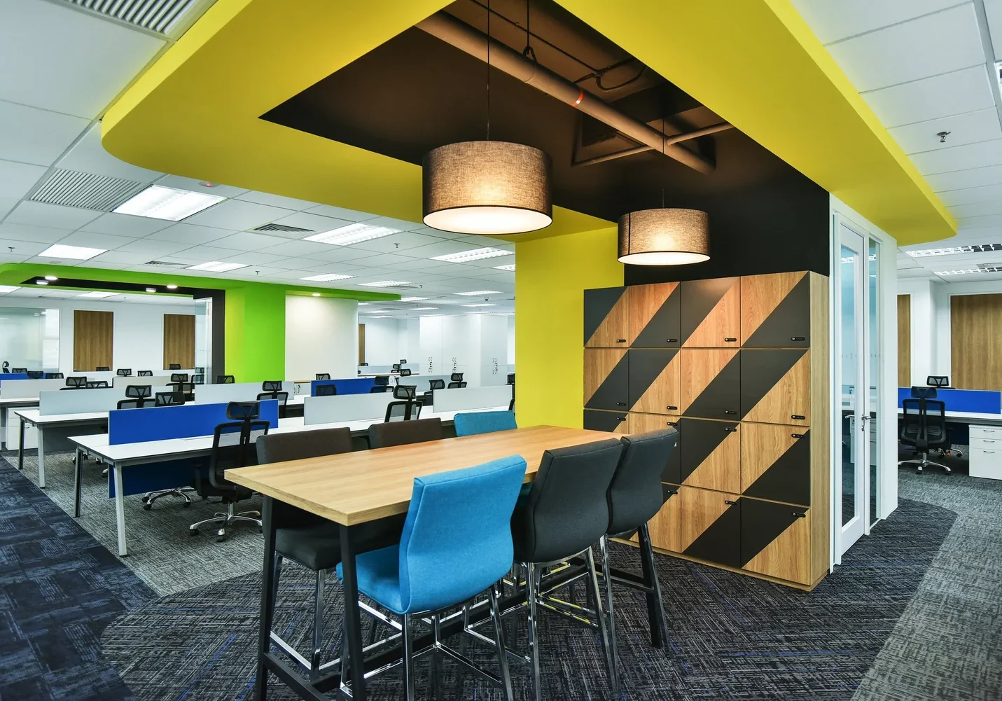 Zimmer Biomet open-plan office with blue workstations and collaborative high table
