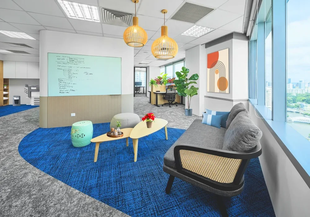 Arohi office breakout lounge with informal seating and Singapore city views